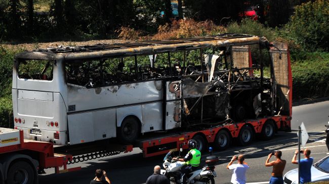 A truck carries the bus damaged by a bomb blast which targeted a group of Israeli tourists at the airport in Bourgas, Bulgaria, on July 19, 2012.